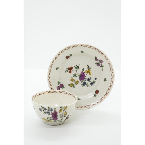 980 - A BRISTOL PORCELAIN TEA BOWL AND SAUCERwith blue 'X' mark and painters marks to bases, 12cm