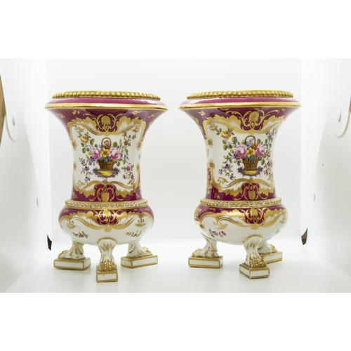 1008 - A PAIR OF ROCKINGHAM VASESCirca 1830, raised on paw feet and painted with floral panels within gold ... 