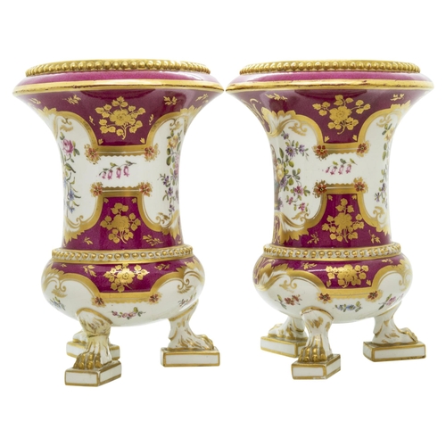 1008 - A PAIR OF ROCKINGHAM VASESCirca 1830, raised on paw feet and painted with floral panels within gold ... 