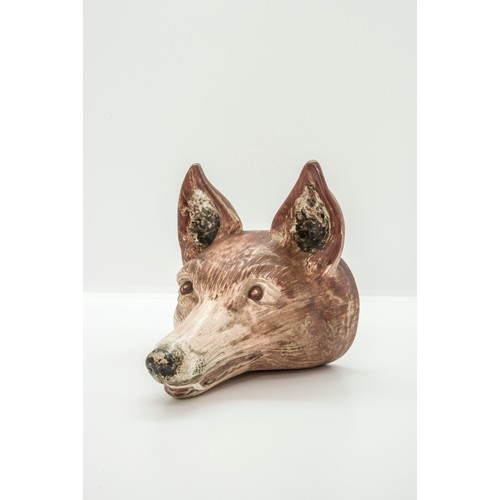 1041 - A PEARLWARE STIRUP CUPCirca 1800 of fox head form, 15cms