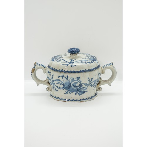 1046 - A DELFT COVERED TWIN HANDLED CUP17th / 18th century 20cms wide