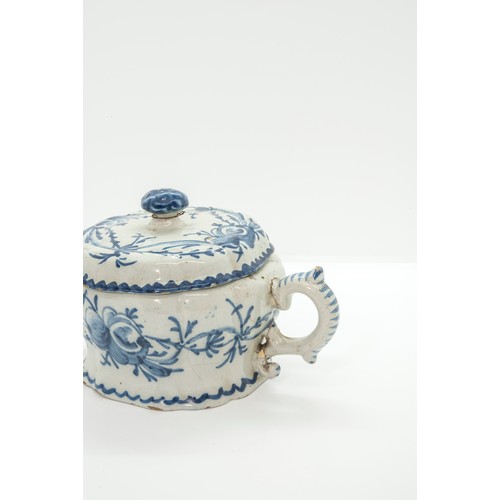 1046 - A DELFT COVERED TWIN HANDLED CUP17th / 18th century 20cms wide