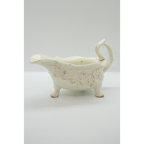 1049 - A MID 18TH CENTURY ENGLISH SAUCEBOATIn blanc de chine style with applied prunus blossom, 20cms wide... 