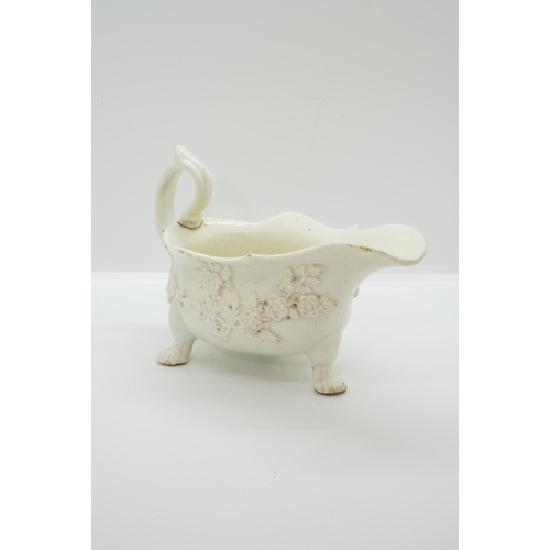 1049 - A MID 18TH CENTURY ENGLISH SAUCEBOATIn blanc de chine style with applied prunus blossom, 20cms wide... 