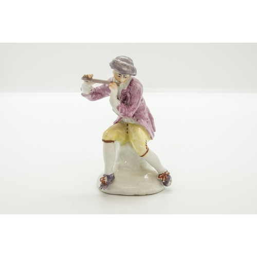 1064 - A MID 18TH CENTURY FIGURE OF A SEATED PIPER, PROBABLY BOWCirca 1755, with square hole for a metal mo... 