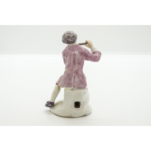 1064 - A MID 18TH CENTURY FIGURE OF A SEATED PIPER, PROBABLY BOWCirca 1755, with square hole for a metal mo... 