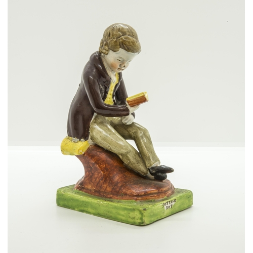 1077 - A PEARLWARE FIGURE OF SEATED BOY READINGCirca 1820, the base entitled 'COTTAGE BOY', 14.5cms high... 