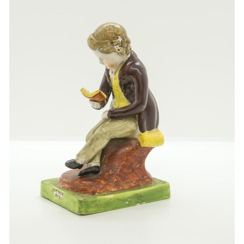 1077 - A PEARLWARE FIGURE OF SEATED BOY READINGCirca 1820, the base entitled 'COTTAGE BOY', 14.5cms high... 