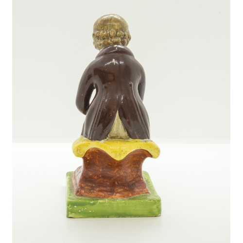 1077 - A PEARLWARE FIGURE OF SEATED BOY READINGCirca 1820, the base entitled 'COTTAGE BOY', 14.5cms high... 