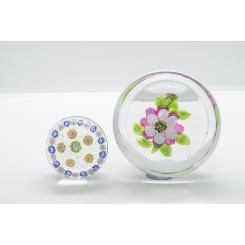 1254 - A FLOWER PAPERWEIGHT AND A SMALL MILLEFIORE WEIGHTLate 19th century, largest is 8cms