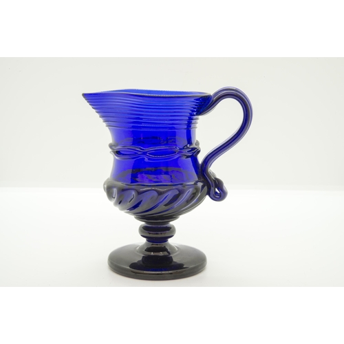 1255 - A 'BRISTOL' BLUE JUG18th century, raised on a foot, 12cms high