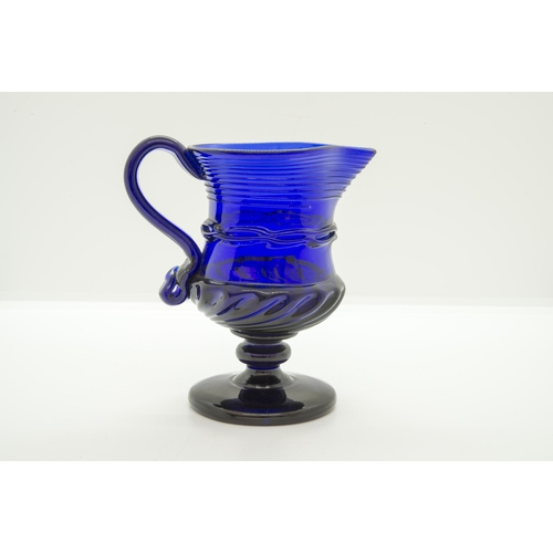 1255 - A 'BRISTOL' BLUE JUG18th century, raised on a foot, 12cms high