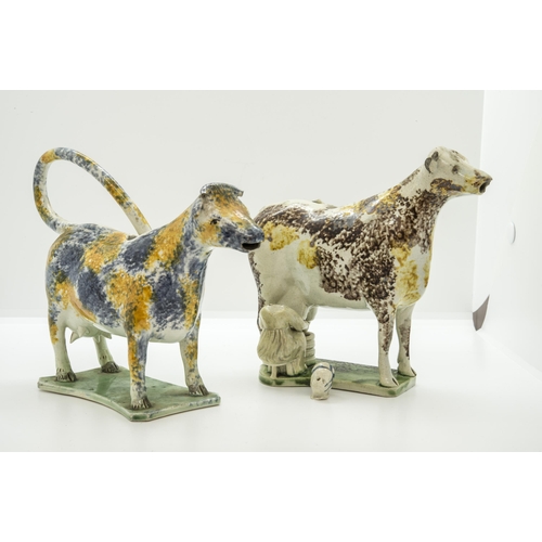 1087 - TWO PEARLWARE COW CREAMERS, PROBBALY NEWCASTLECirca 1810, one with seated milkmaid, 19cms