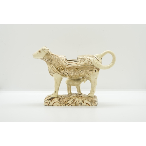 1089 - A PINK LUSTRE COW CREAMER AND MARBLED COW CREAMERCirca 1840, the marbled example with calf, 19cms... 