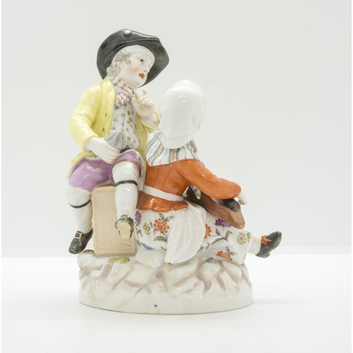 1095 - A BERLIN FIGURE GROUP19th Century, a woman with a hurdy-gurdy and a man with a  magic lantern, 16cms... 