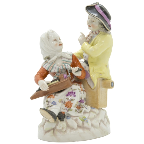 1095 - A BERLIN FIGURE GROUP19th Century, a woman with a hurdy-gurdy and a man with a  magic lantern, 16cms... 