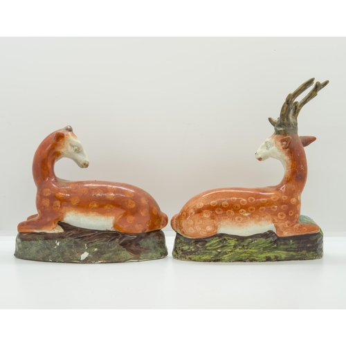 1098 - A PAIR OF STAFFORDSHIRE RECUMBANT DEERCirca 1830, 19cms high