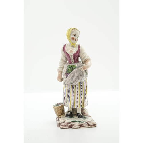 1102 - THREE FAIENCE FIGURES18th century or later, a shepherdess, a grape harvester and a hurdy-gurdy playe... 