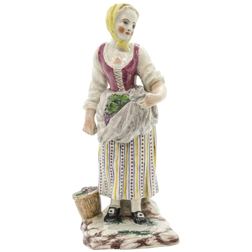 1102 - THREE FAIENCE FIGURES18th century or later, a shepherdess, a grape harvester and a hurdy-gurdy playe... 