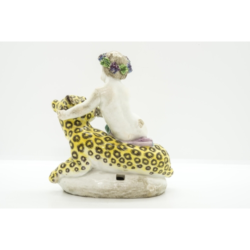 1109 - AN EIGHTEENTH CENTURY FIGURE OF A CUPID ON A LEOPARD, PROBABBLY BOWCirca 1760, 15cms high