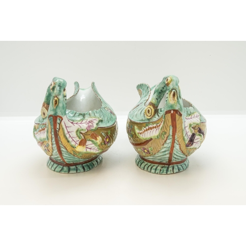 1112 - AN UNUSUAL PAIR OF WORCESTER LEAF SAUCE BOATS WITH LATER CLOBBERED DECORATION18th century, 18cms wid... 