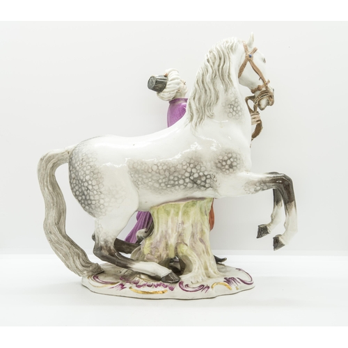 1126 - AN EQUESTRIAN FIRGURE OF A HORSE WITH TURKISH ATTENDANT19th century, probably Meissen, incised '135 ... 