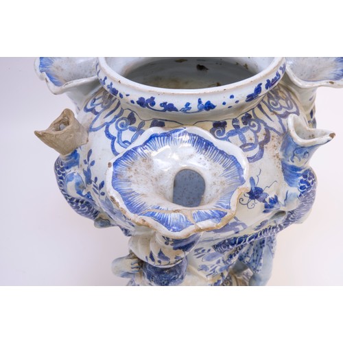 1131 - A PAIR OF DELFT TULIP VASES18th century, three cherubs with cornucopia supporting central vase flank... 