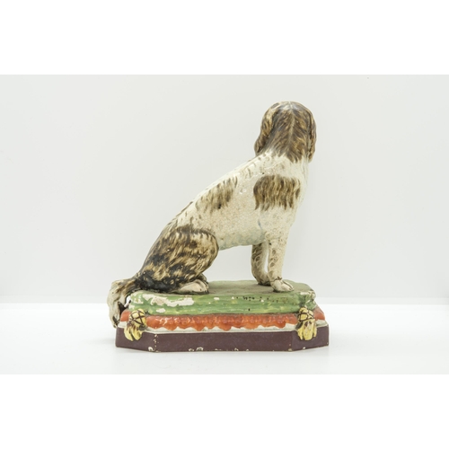 1136 - A PEARLWARE MODEL OF A HOUNDCirca 1830, 18cms high