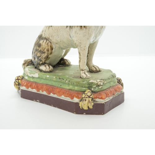 1136 - A PEARLWARE MODEL OF A HOUNDCirca 1830, 18cms high