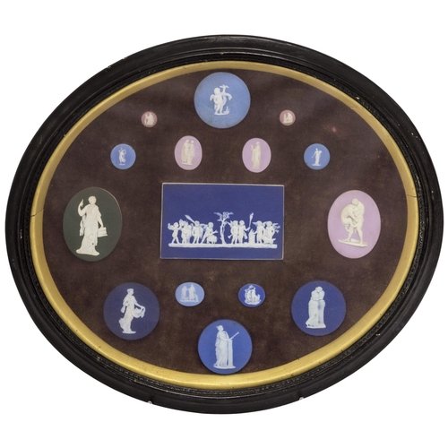 1148 - A LARGE OVAL CASE CONTAINING FIFTEEN WEDGWOOD PLAQUES, 49CMS wideGlass cover is cracked