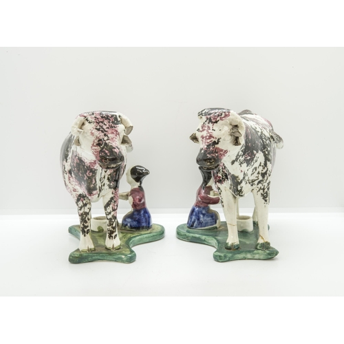 1154 - A PAIR OF SPONGED COW CREAMERSCirca 1840, with attendant milk maids on wafer bases, 19cms long