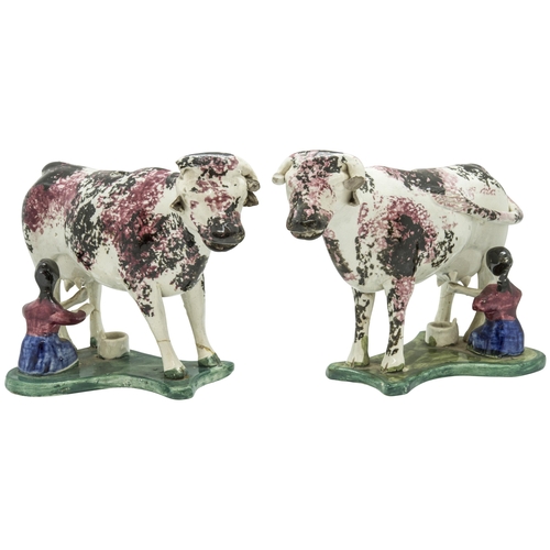 1154 - A PAIR OF SPONGED COW CREAMERSCirca 1840, with attendant milk maids on wafer bases, 19cms long