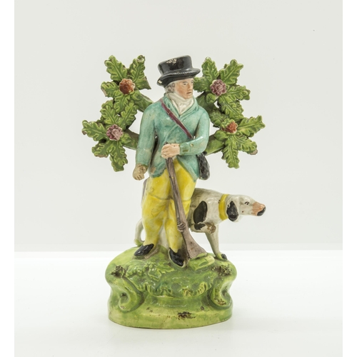 1174 - A BOVAGE GROUP OF A SPORTSMAN AND HIS DOGCirca 1830, 8cms high