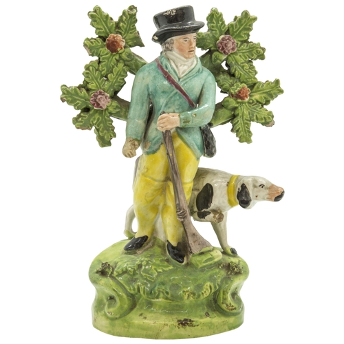 1174 - A BOVAGE GROUP OF A SPORTSMAN AND HIS DOGCirca 1830, 8cms high