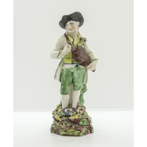 1176 - A PEARLWARE FIGURE OF A HURDY-GURDY PLAYER Circa 1830, 20cms high