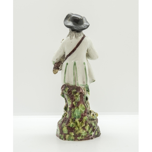 1176 - A PEARLWARE FIGURE OF A HURDY-GURDY PLAYER Circa 1830, 20cms high