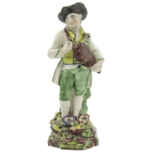 1176 - A PEARLWARE FIGURE OF A HURDY-GURDY PLAYER Circa 1830, 20cms high