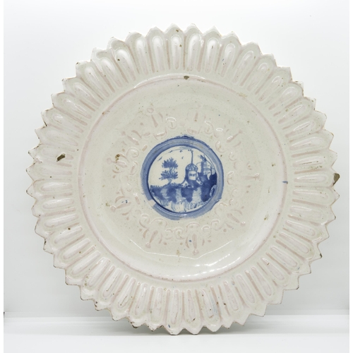 1194 - A WHITE TIN GLAZED RELIEF MOULDED CHARGER17th / 18th  century, 34.5cms wide