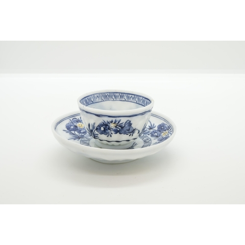 1271 - A EUROPEAN MILK GLASS TEA BOWL AND SAUCER18th century, decorated in imitation of Chinese export blue... 