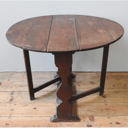 1714 - AN OAK GATE-LEG TABLELATE 17TH/EARLY 18TH CENTURYof compact proportions, the hinged oval top raised ... 