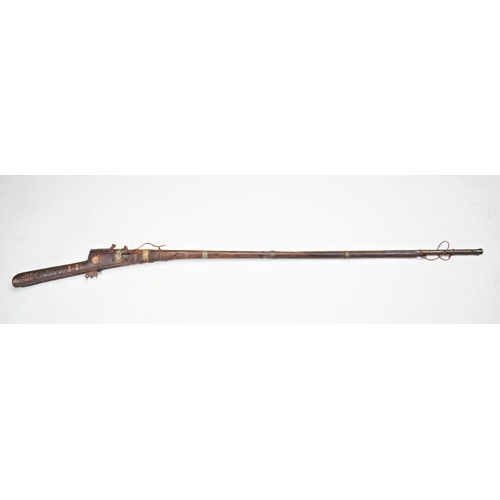 600 - A INDIAN 19TH CENTURY MATCHLOCK GUN, the stock variously decorated and inlaid with brass and camel b... 