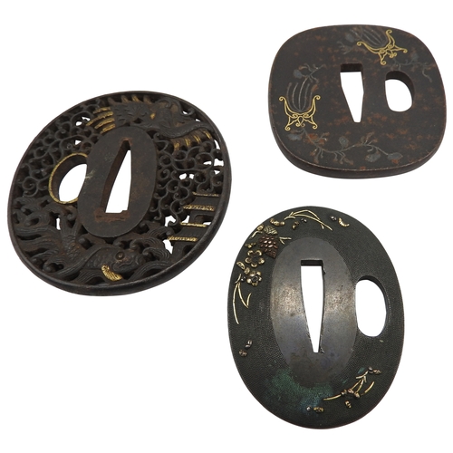 2224 - A RETICULATED JAPANESE IRON TSUBA decorated with a dragon in a stylised sky, a pagoda and a fish, an... 