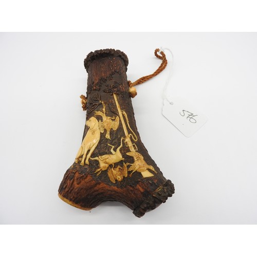 656 - A 19TH CENTURY STAG HORN POWDER FLASK, probably German, intricately carved with a hunting dog, rifle... 