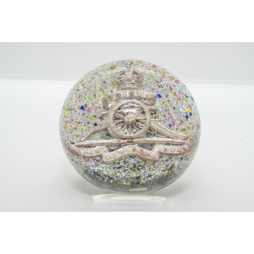 673 - A ROYAL ARTILLERY GLASS PAPERWEIGHT with RA cap badge on a mottled background with rough broken pont... 