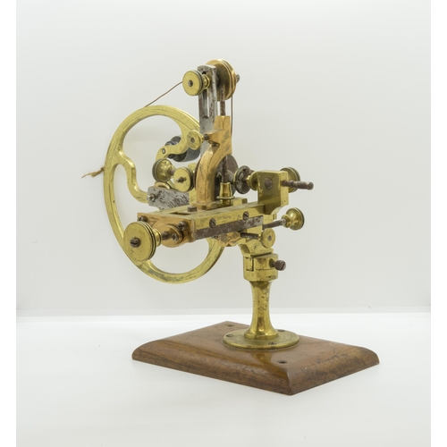 1504 - AN ANTIQUE WATCHMAKERS LATHE,19th century, in brass and steel on a mahogany base.16 x 28 cms... 