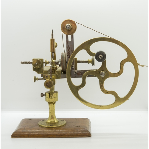 1504 - AN ANTIQUE WATCHMAKERS LATHE,19th century, in brass and steel on a mahogany base.16 x 28 cms... 