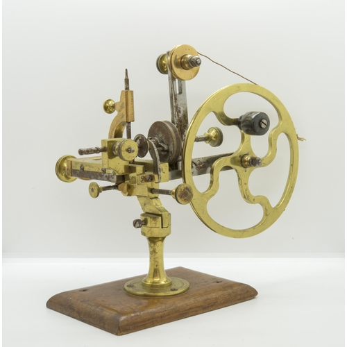 1504 - AN ANTIQUE WATCHMAKERS LATHE,19th century, in brass and steel on a mahogany base.16 x 28 cms... 