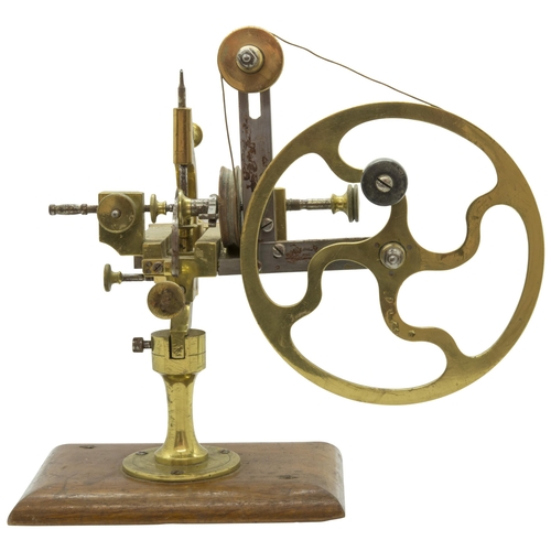 1504 - AN ANTIQUE WATCHMAKERS LATHE,19th century, in brass and steel on a mahogany base.16 x 28 cms... 