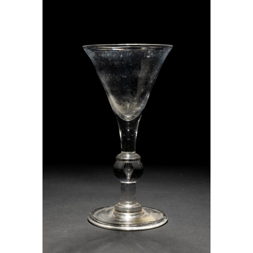 1281 - A LARGE GEORGIAN TRUMPET SHAPED GLASS the knopped stem with teardrop inclusion upon a folded foot. 2... 