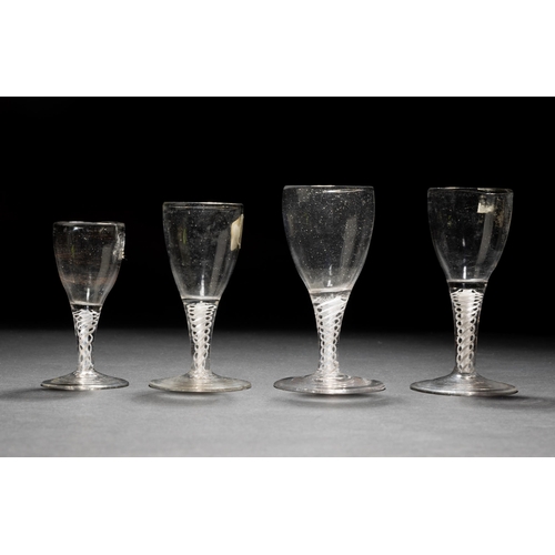 1286 - A GEORGIAN SHORT OPAQUE TWIST WINE GLASS AND THREE OTHERS SIMILAR. 13 cms max